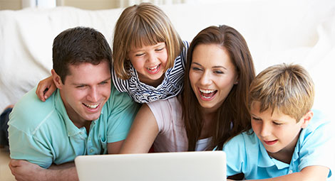 Family looking at a computer together